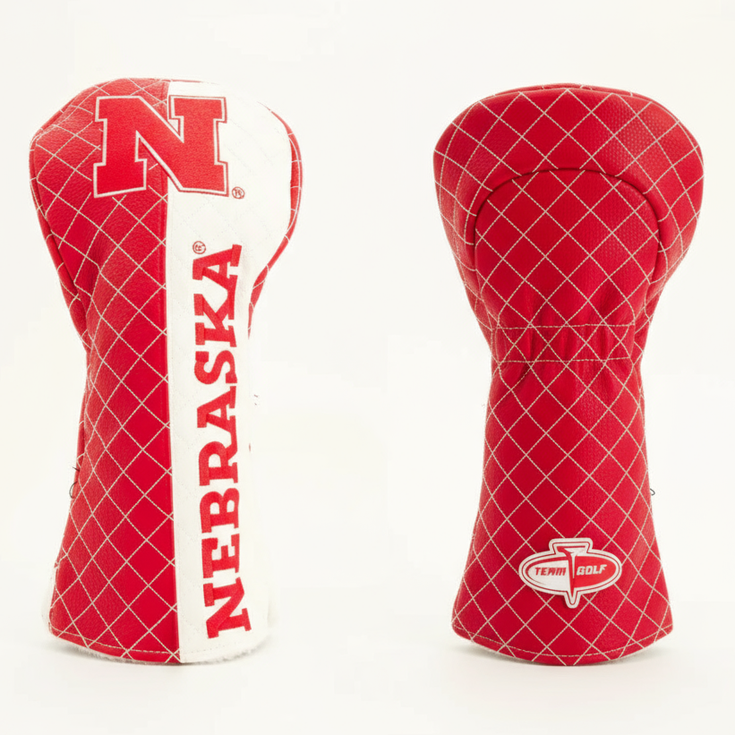 Red and white golf club head covers with 'Nebraska' branding on a light beige background