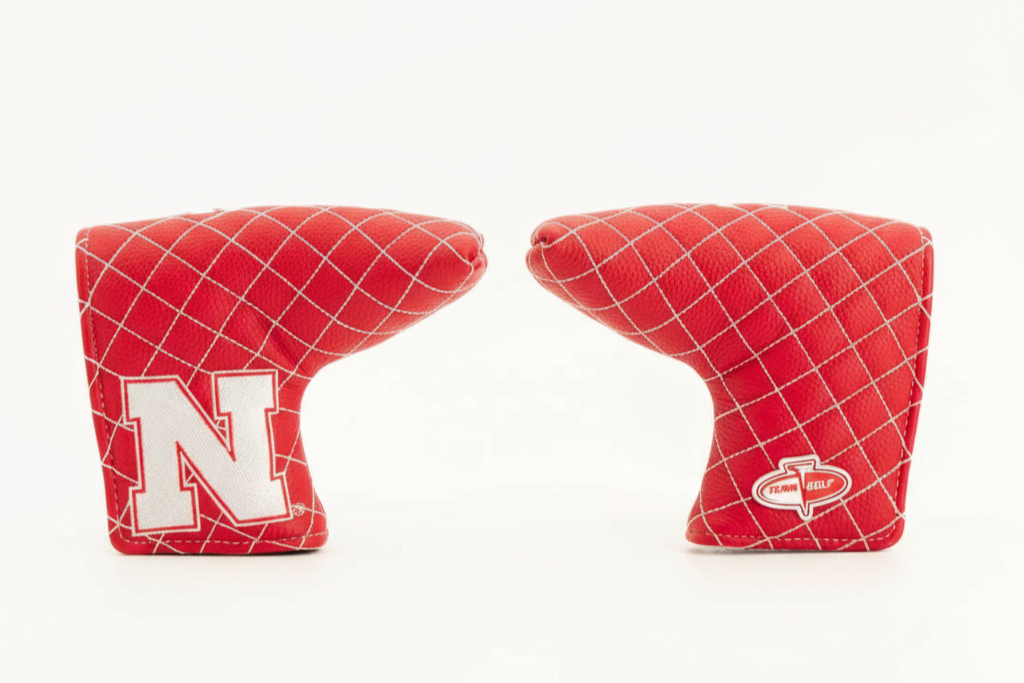 Two red golf club covers with a white 'N' logo on a white background