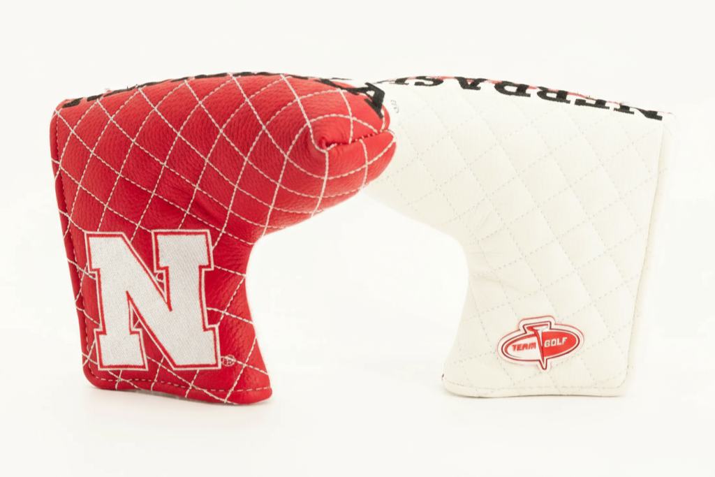 Red and white golf club head cover with 'N' logo on a white background