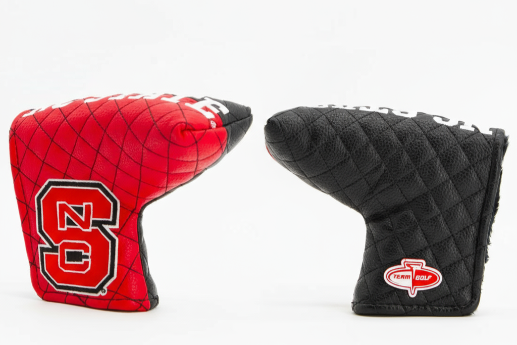 Red and black golf club head covers on a white background