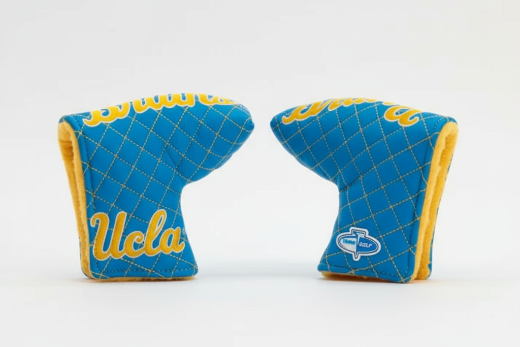 Two blue and yellow UCLA golf club covers on a white background