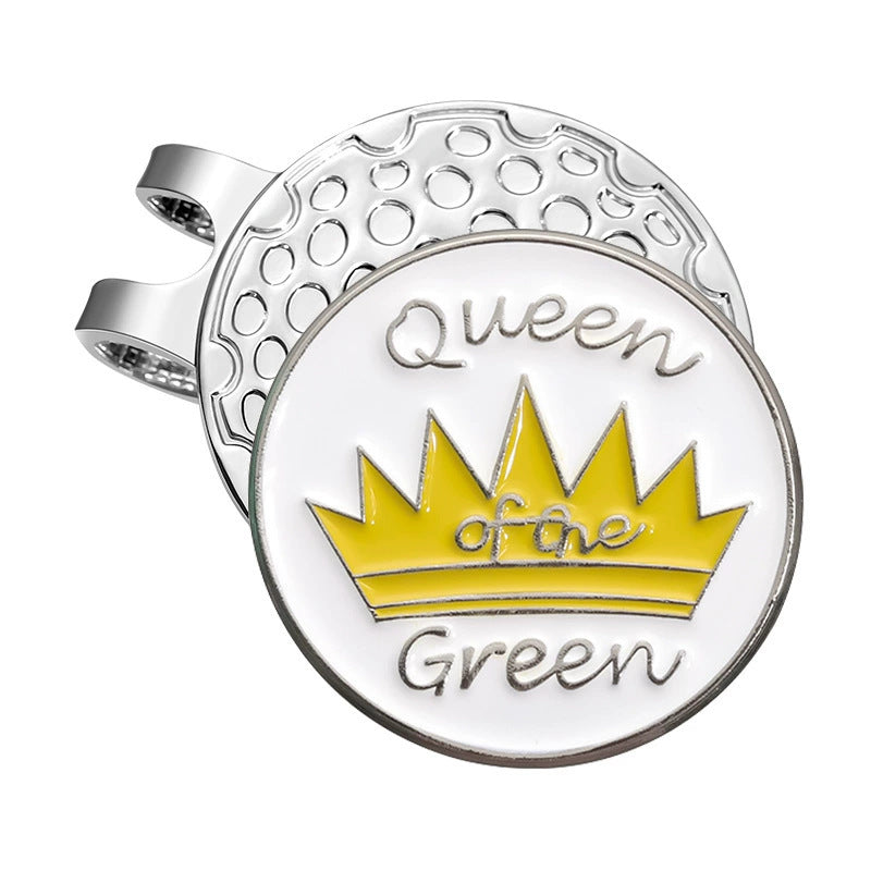 Silver golf ball marker with yellow crown and 'Queen of the Green' text on white background, attached to a magnet hat clip