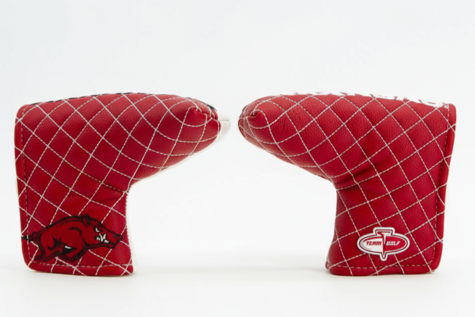Two red golf club covers with a grid pattern on a white background