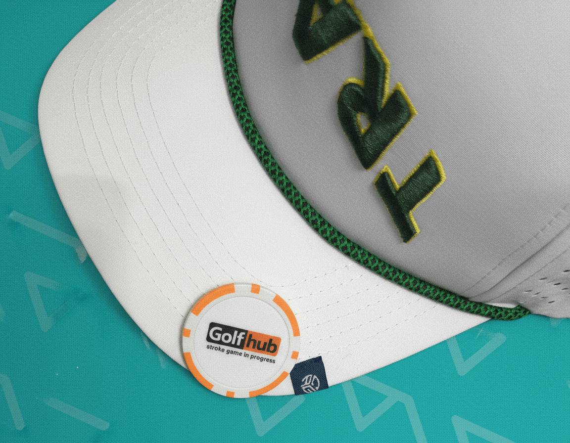 White cap with green brim and 'Golf hub' logo on a teal background