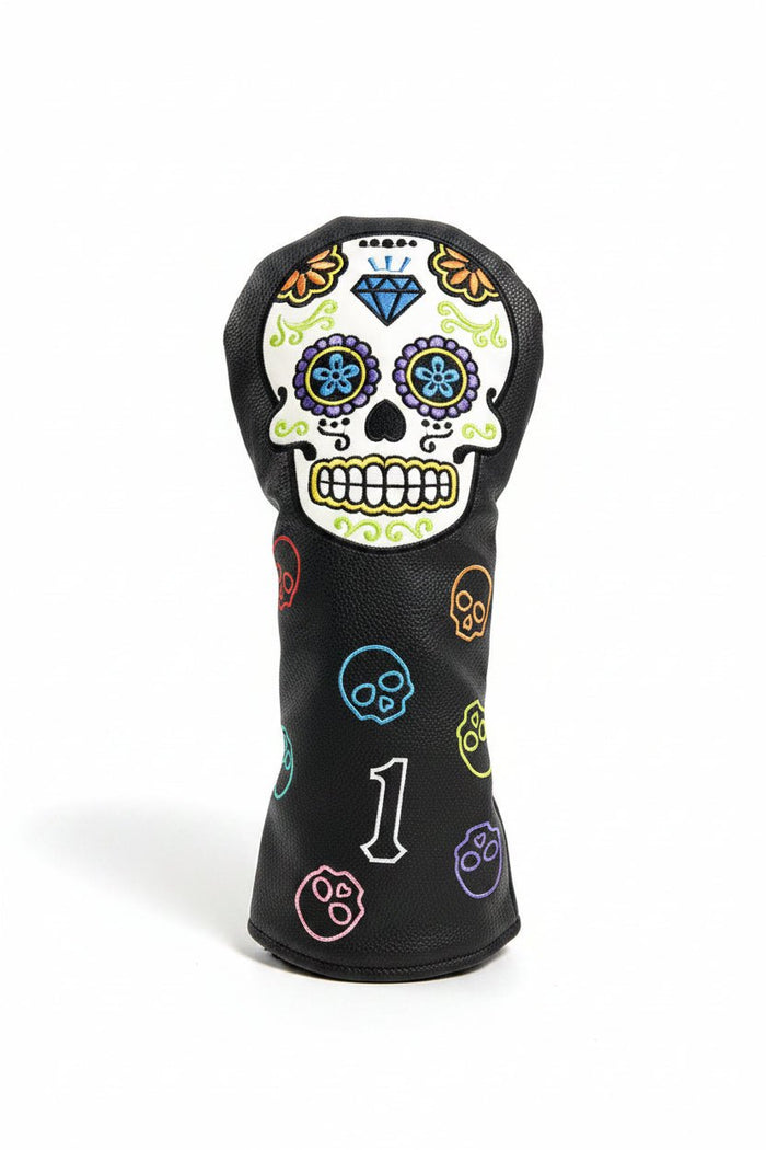 Golf club head cover with colorful skull design on grass