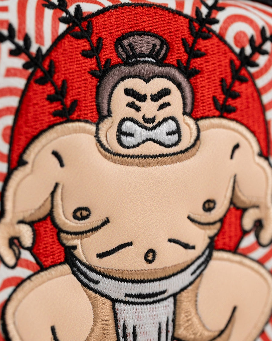 Sumo wrestler embroidery against red circle and swirling patterned front