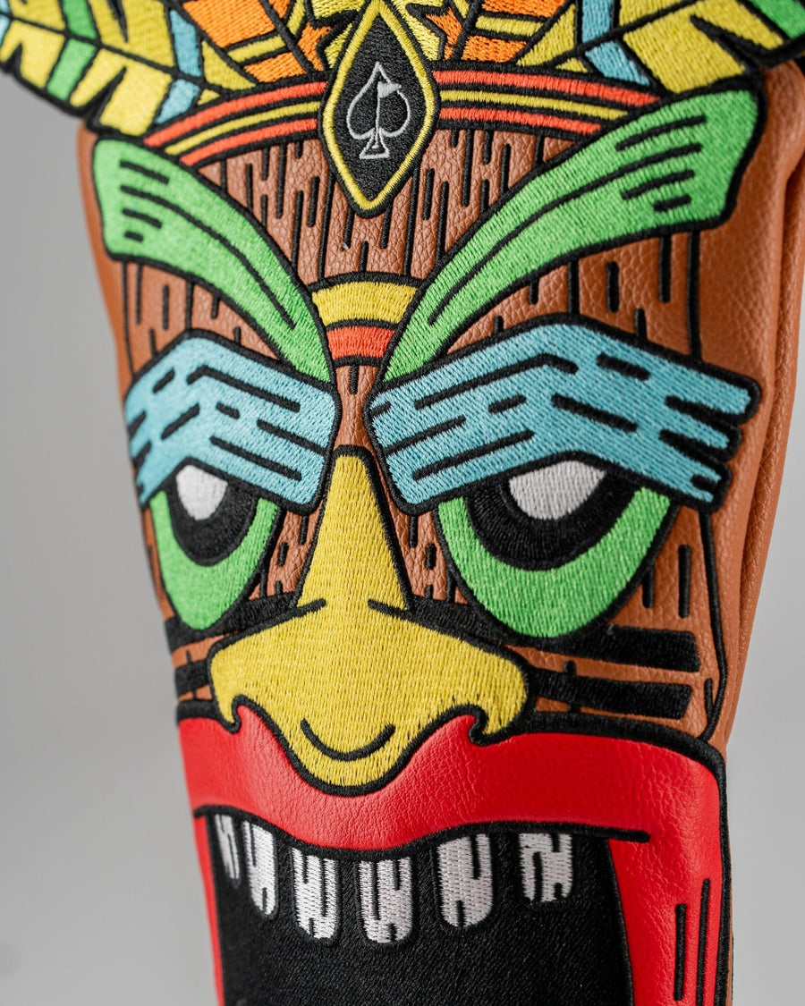 Close-up of the tiki driver's green eyes, blue brows and red mouth