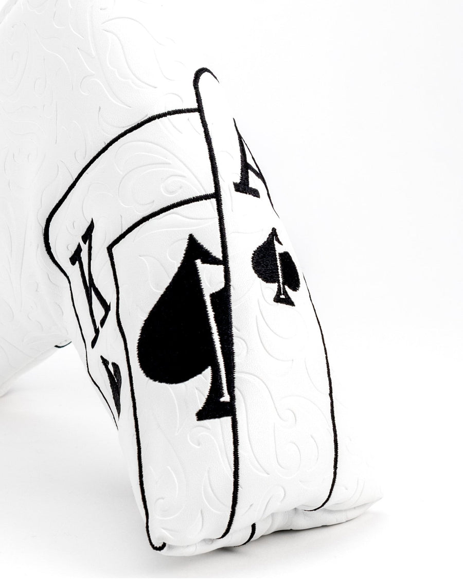 Black ace and spade outlines on the textured white blade cover