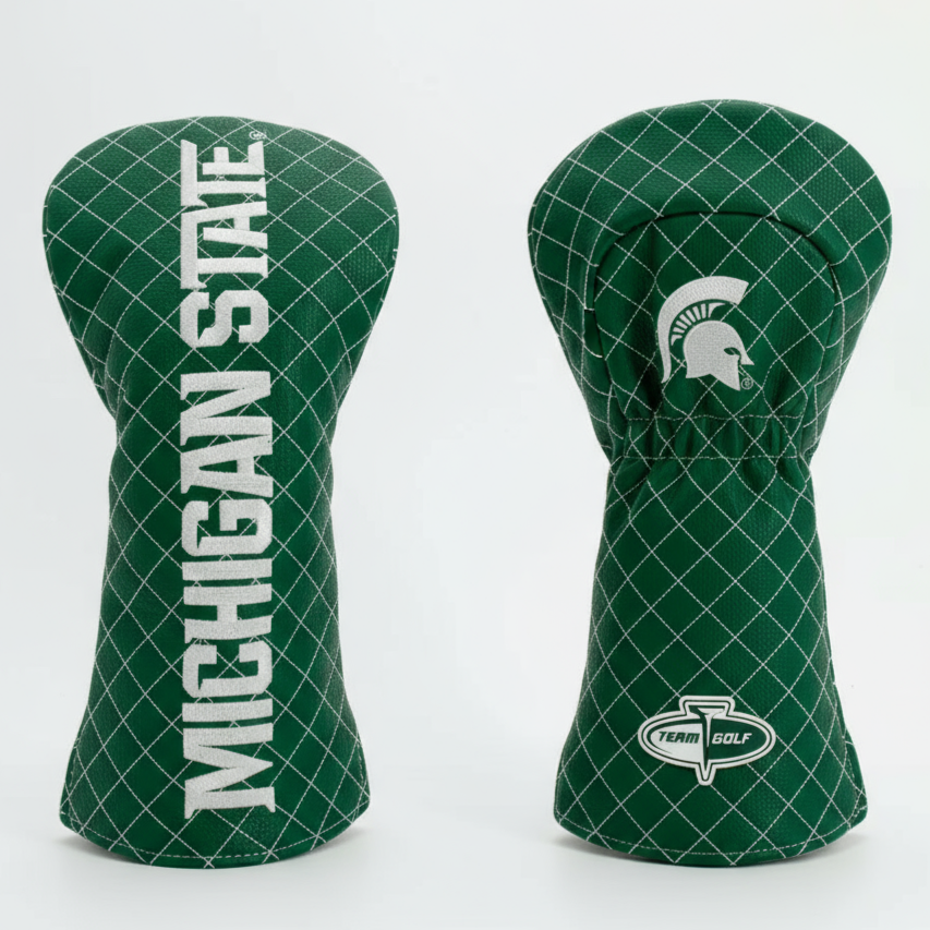 Two green golf club head covers with 'Michigan State' text and logo on a white background