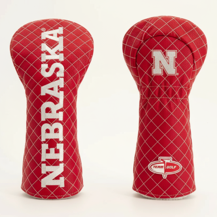 Two red golf club head covers with 'Nebraska' and a logo on a white background