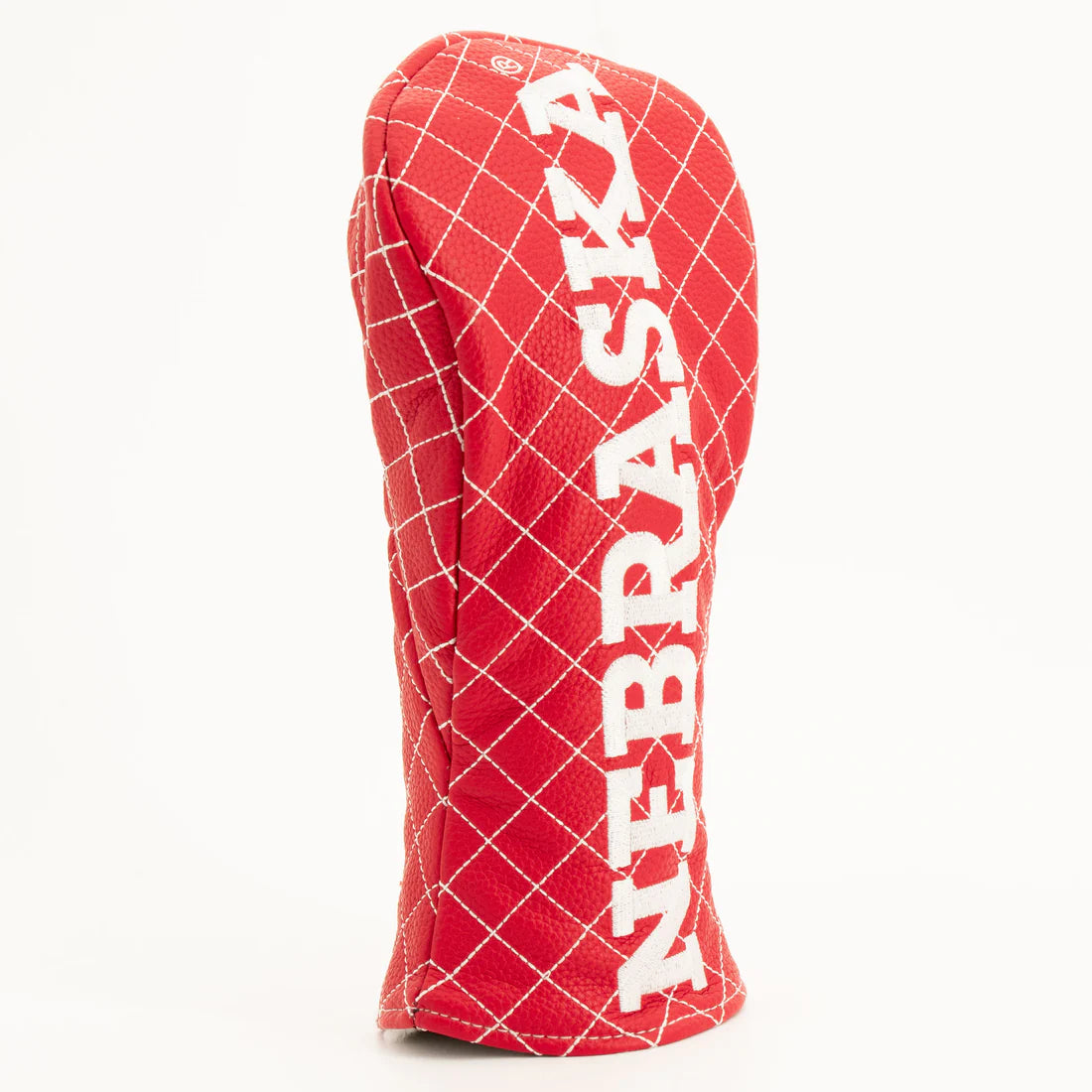 Red grid-patterned golf club head cover with 'NEBRASKA' text on a white background