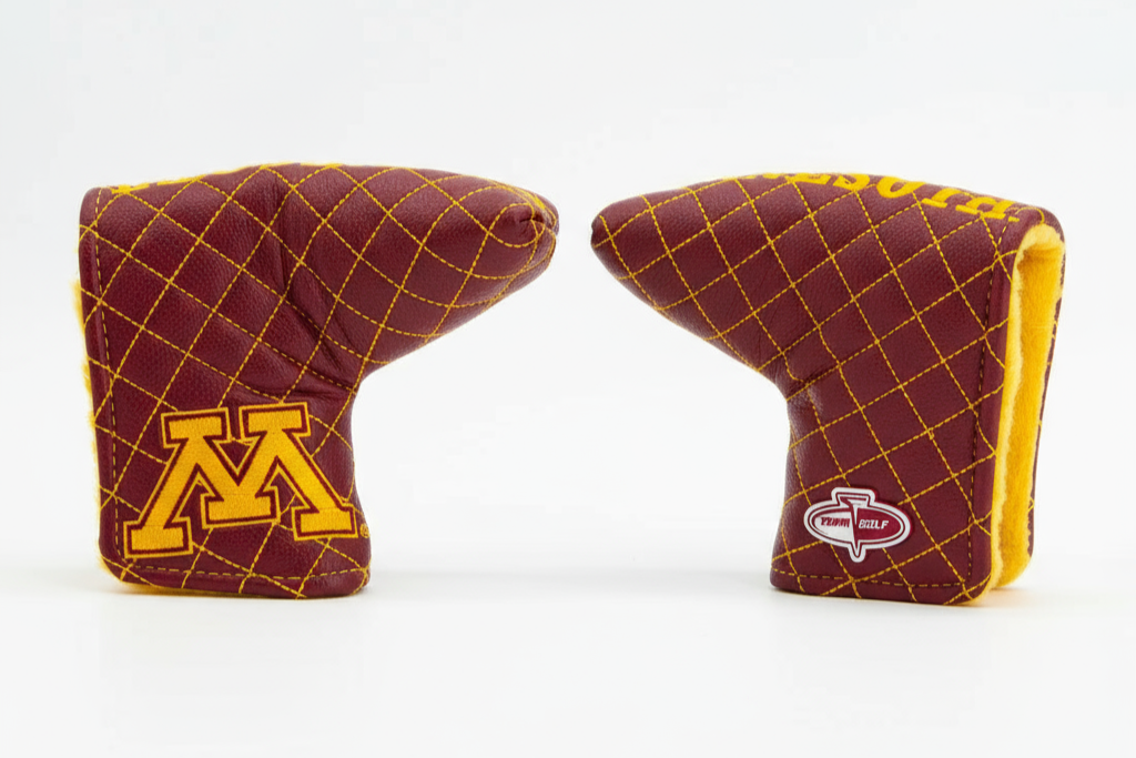 Two maroon and gold golf club head covers on a white background