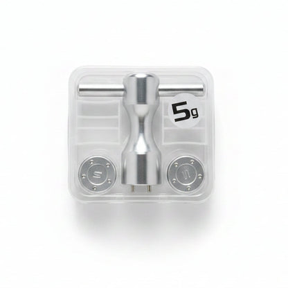 Metallic valve handle set in clear packaging on a marble surface