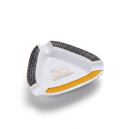 Cohiba ashtray with white, orange, and black design on a beige background