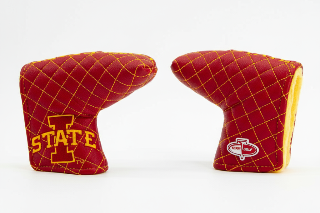 Two red golf club covers with yellow stitching on a white background
