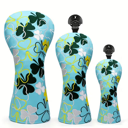 Three golf club heads with floral pattern on a white background