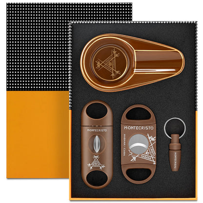 Montecristo cigar accessories set including a cutter, humidor, and keychain on a black background.