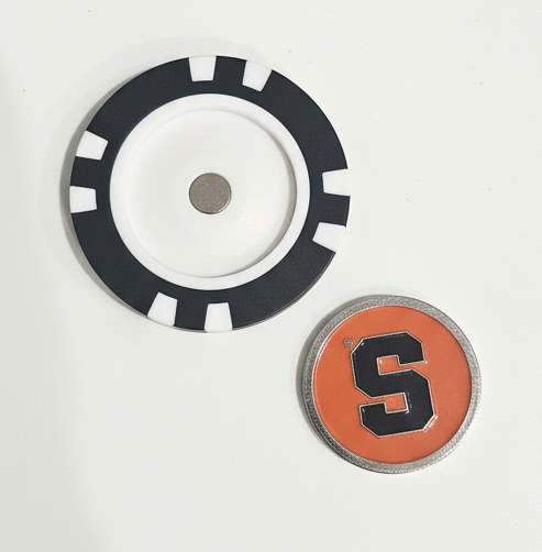 Two circular objects with a black and white design and an orange and black design on a white background