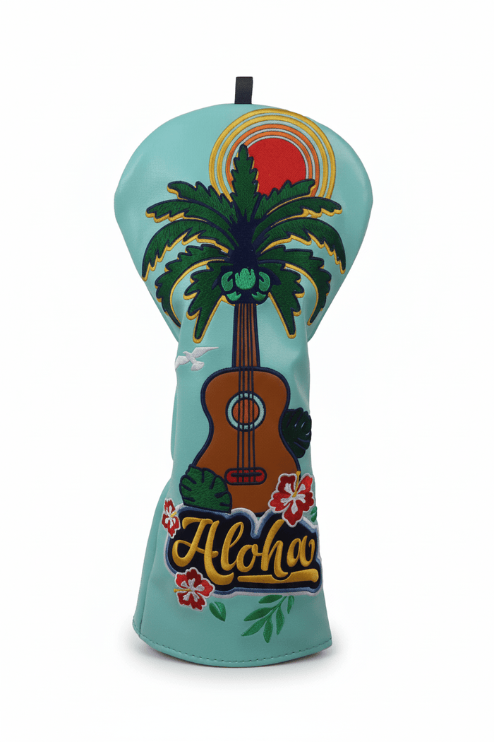 Headcover with guitar, palm tree, and 'Aloha' design on a light blue background