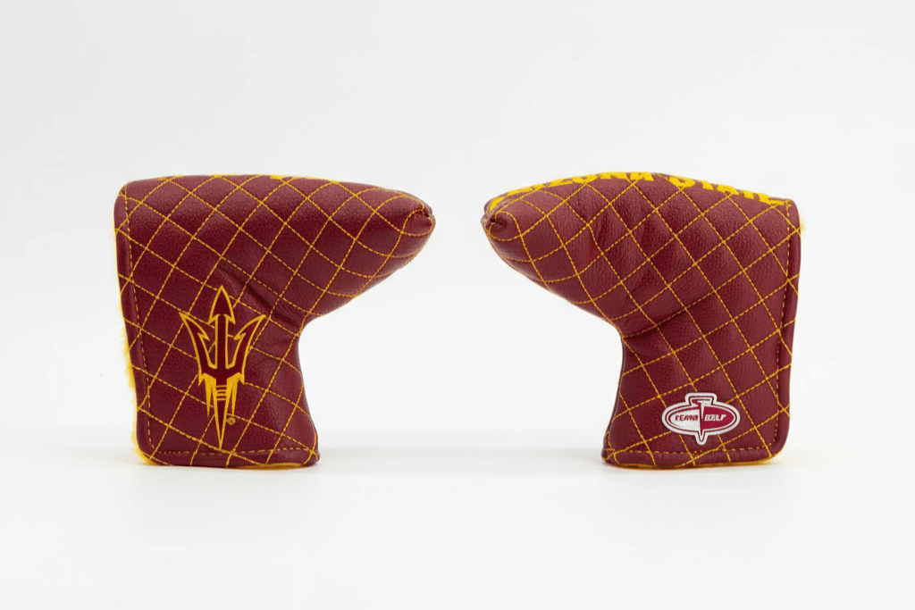 Two maroon and gold golf club head covers on a white background