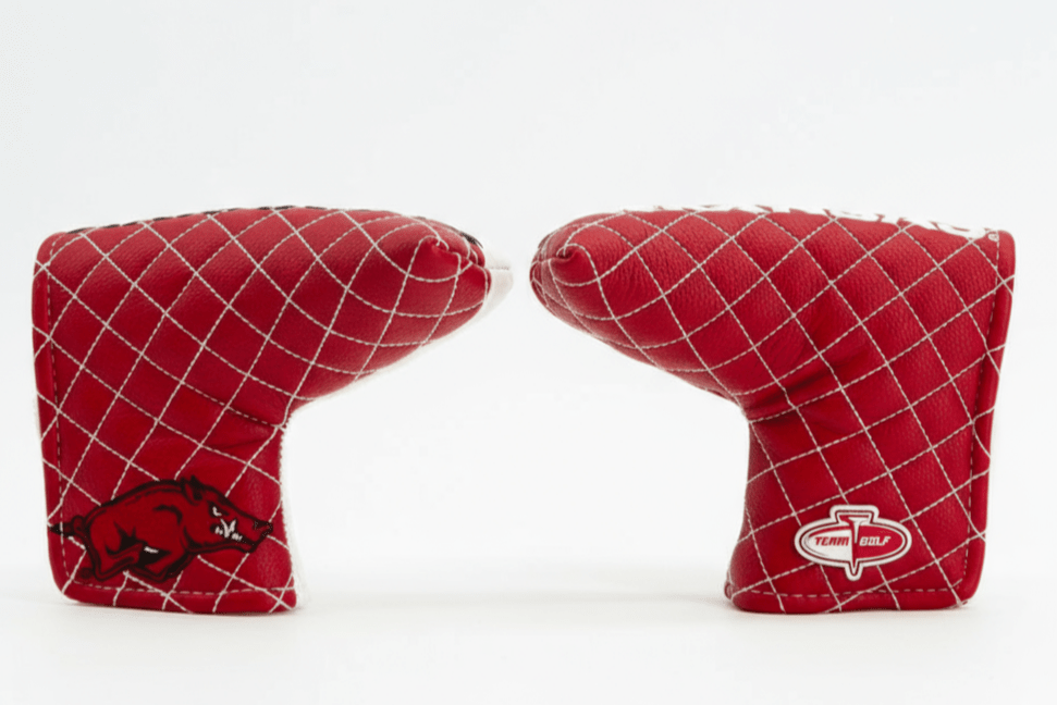Two red golf club covers with a grid pattern on a white background