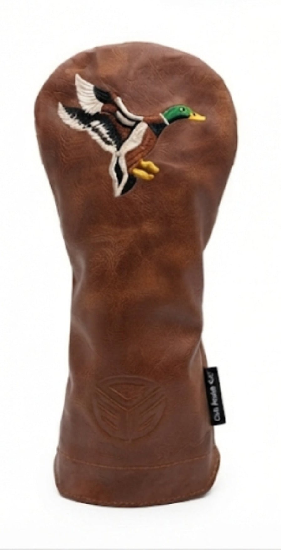 A brown leather golf club headcover featuring an embroidered mallard duck in flight on the front, with a small black brand tag on the lower right.