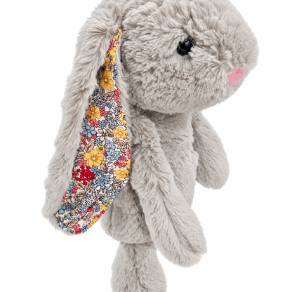 Close-up of flower-patterned ear lining, gray plush and pink nose on bunny headcover