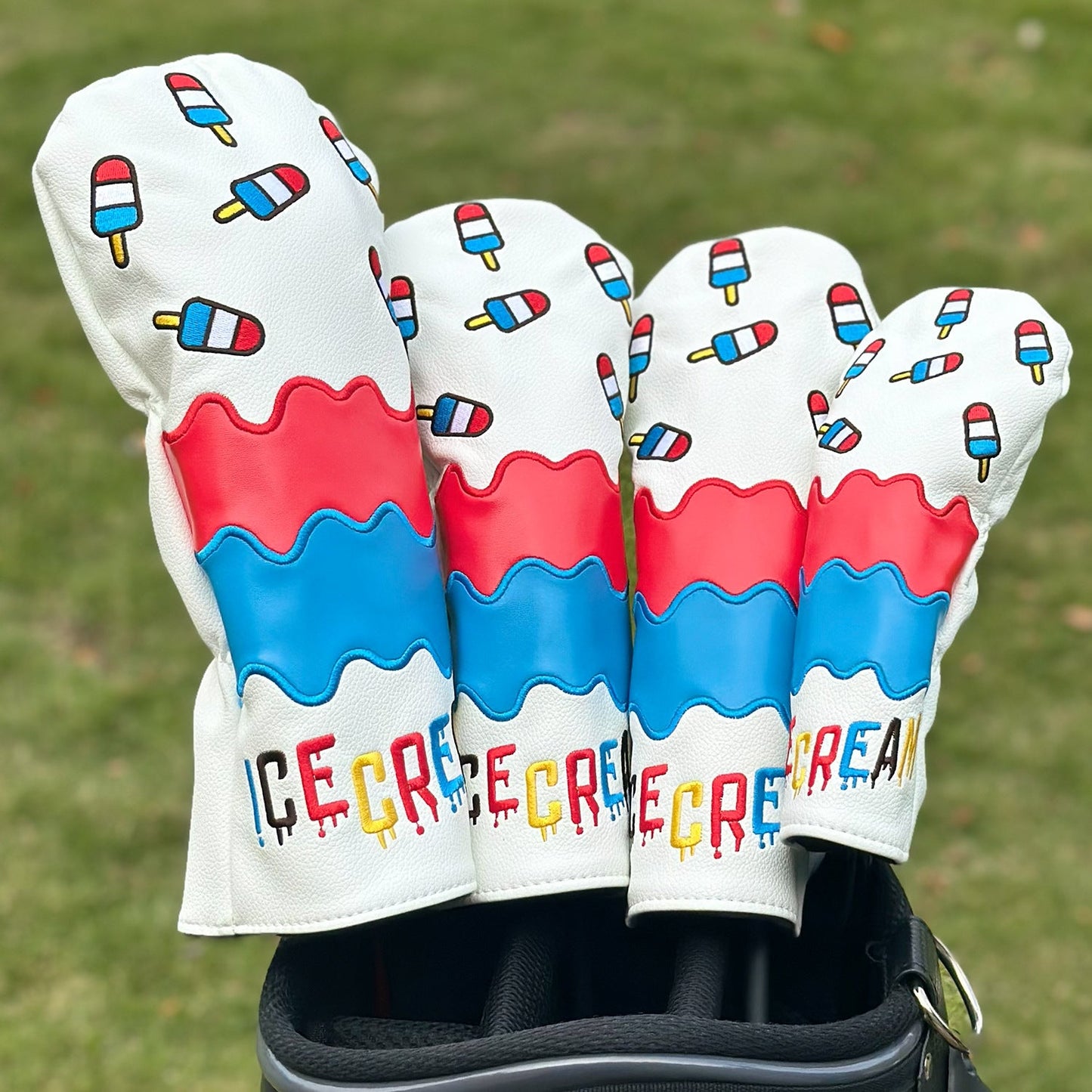 Golf club head covers with ice cream design on a grass background