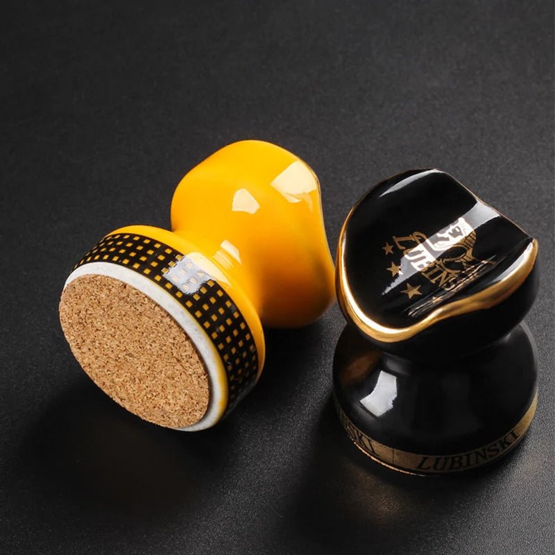 The two ceramic stands with the underside of the yellow stand visible