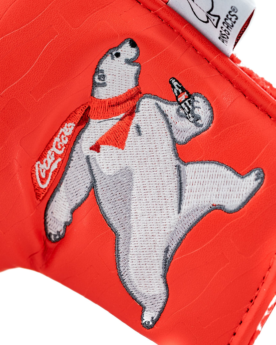White and gray polar bear wearing a red Coca-Cola scarf