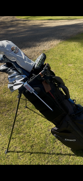 CoverStick rotated down alongside a golf bag in its stowed position