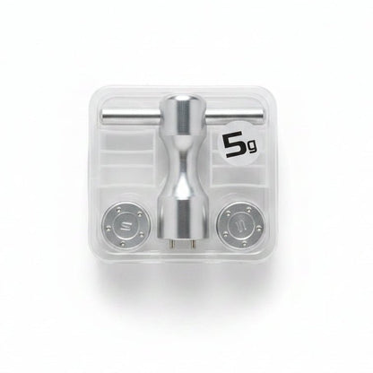 Metallic valve handle set in clear packaging on a marble surface