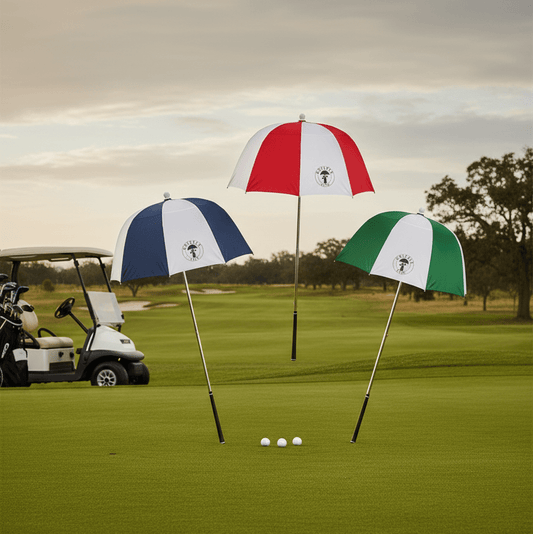 Three golf umbrellas with different color combinations on a golf course.