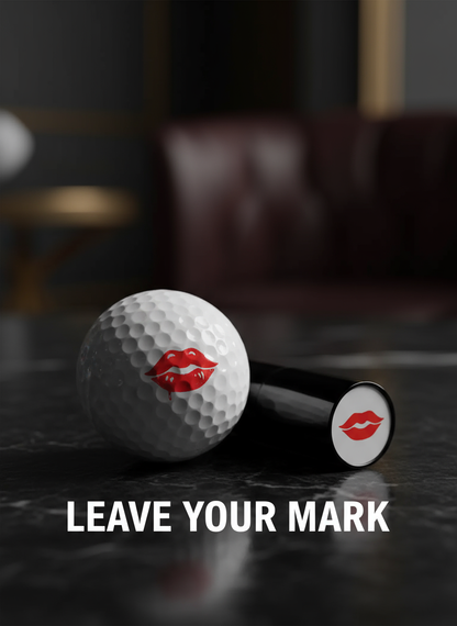 Golf ball and lip-shaped object with red lipstick prints on a dark surface, text 'Leave Your Mark' below.
