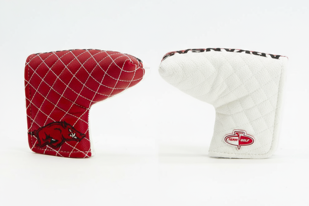 Red and white golf club head covers on a white background