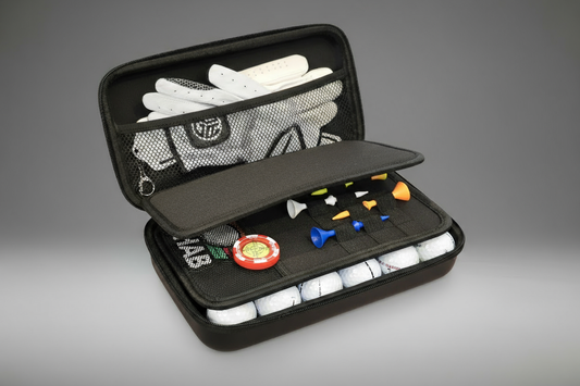 Golf accessories including gloves, tees, and balls in a black case on a gray background