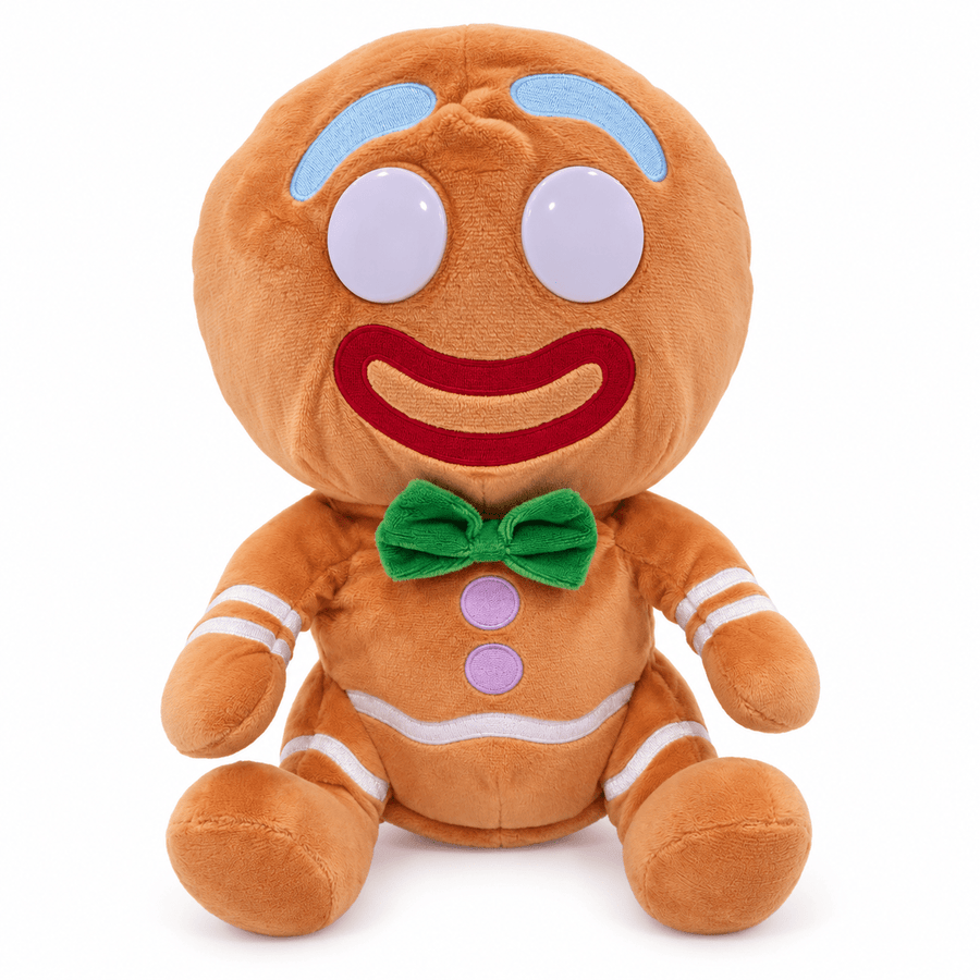 A plush gingerbread person toy with a round head, large white eyes, a red embroidered smile, light blue eyebrows, a green bow tie, and white stripe details on a plain white background.