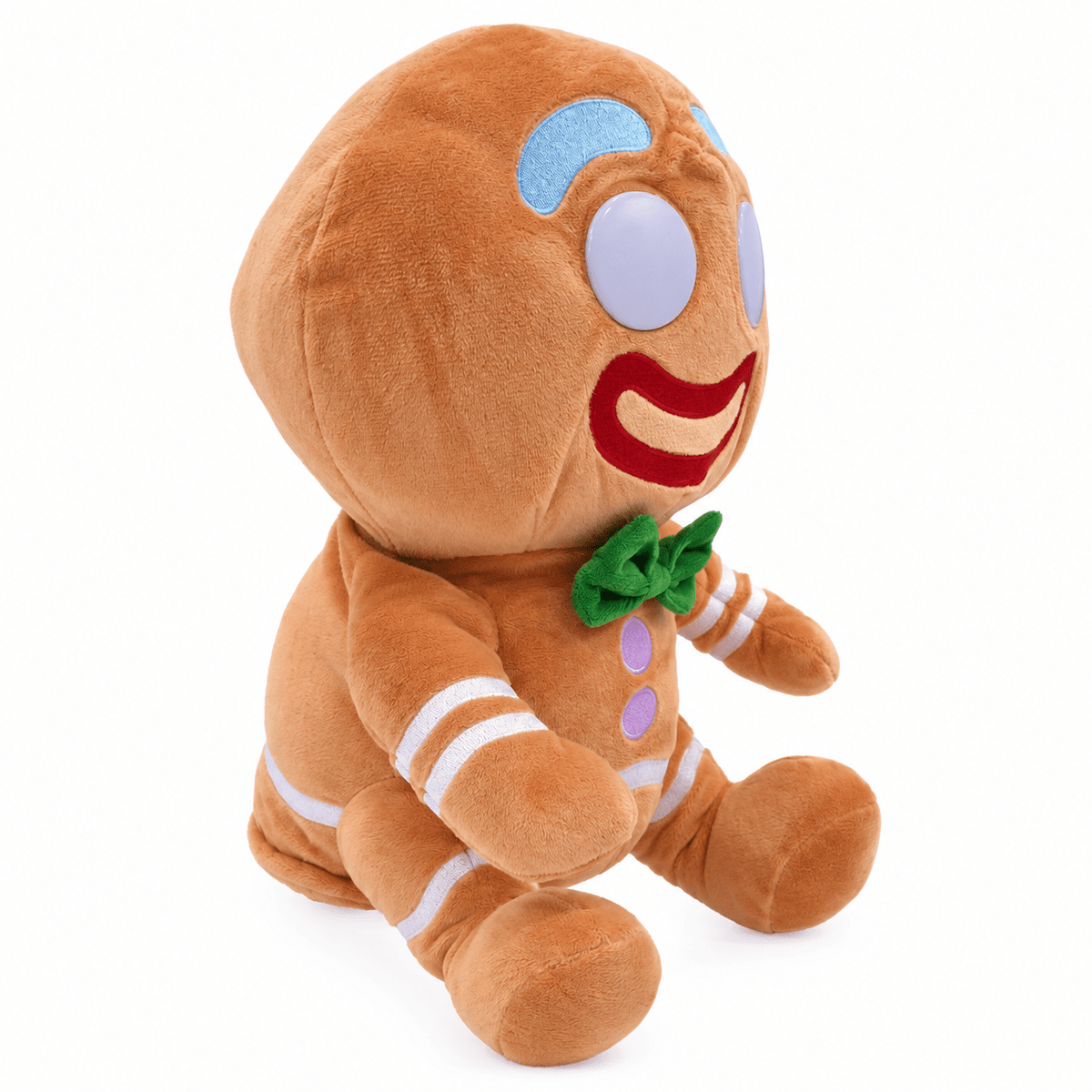 A plush gingerbread man doll sitting upright on a clean white background. The toy features a warm brown body with embroidered details including a green bow tie, purple buttons, white stripes, and a red smile.