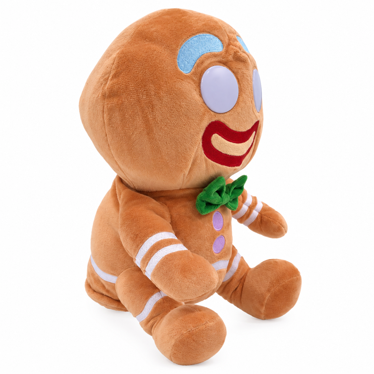A plush gingerbread man doll sitting upright on a clean white background. The toy features a warm brown body with embroidered details including a green bow tie, purple buttons, white stripes, and a red smile.