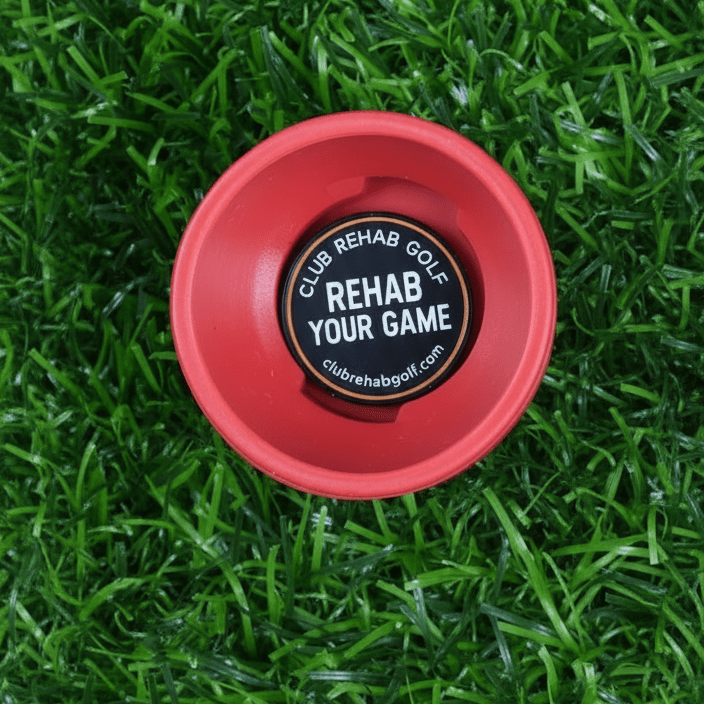 Red cap with 'Rehab Your Game' text on a grass background
