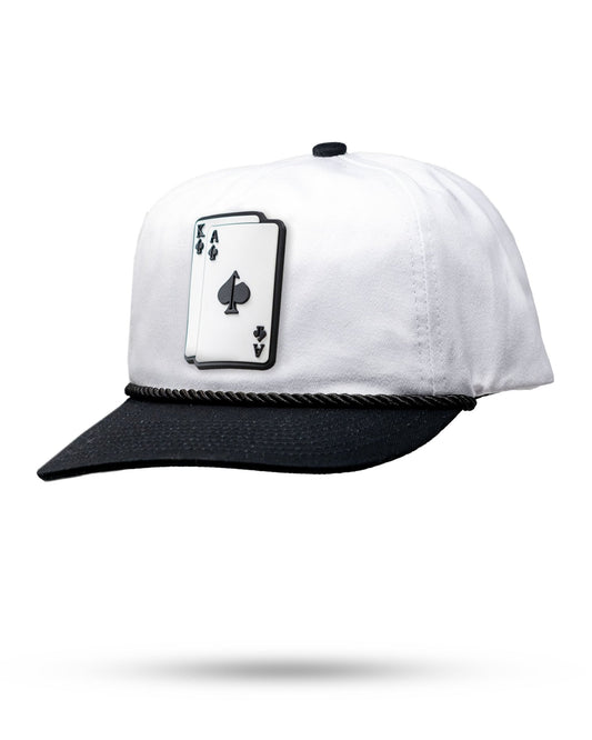White and black cap with a card suit symbol on a white background