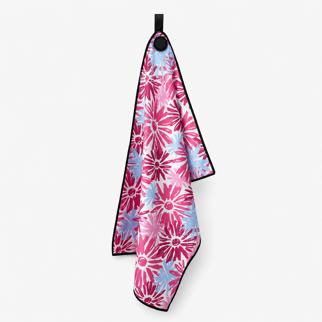 Floral patterned towel hanging on a hook against a white background