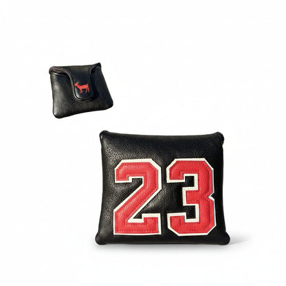 Black and red sports bag with number 23 on grass