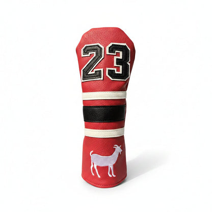 Red golf club head cover with number 23 and goat design on grass