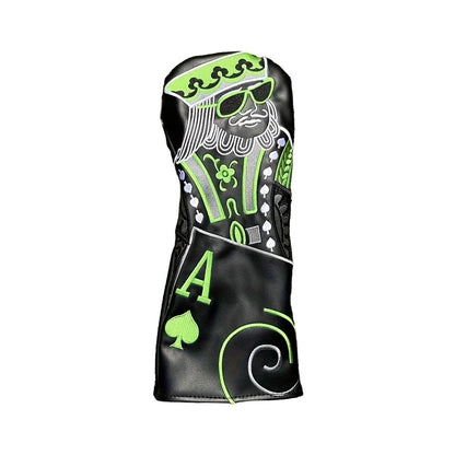 Golf club head cover with green and black design on grass