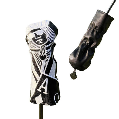 Golf club head cover with intricate design and a black golf glove on a grassy background