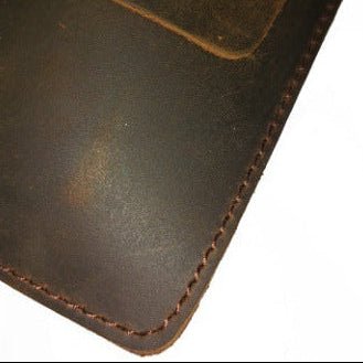 Close-up of a brown leather wallet with visible stitching on a white background