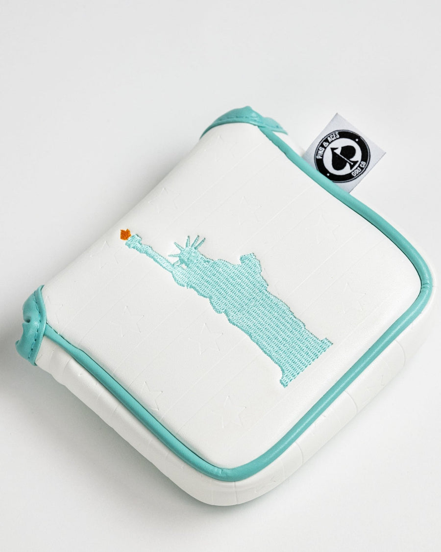 Turquoise Statue of Liberty with orange torch on white mallet cover
