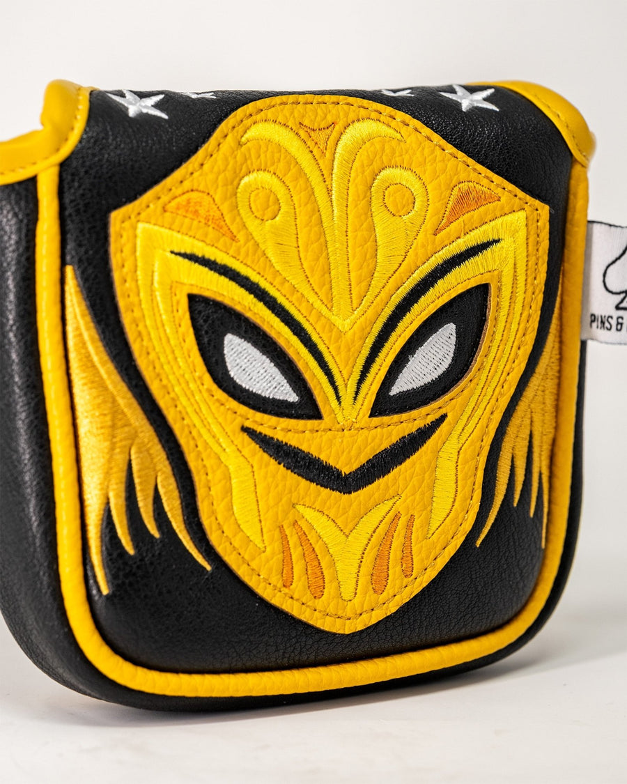 Yellow lucha-mask embroidery on black mallet cover with yellow piping