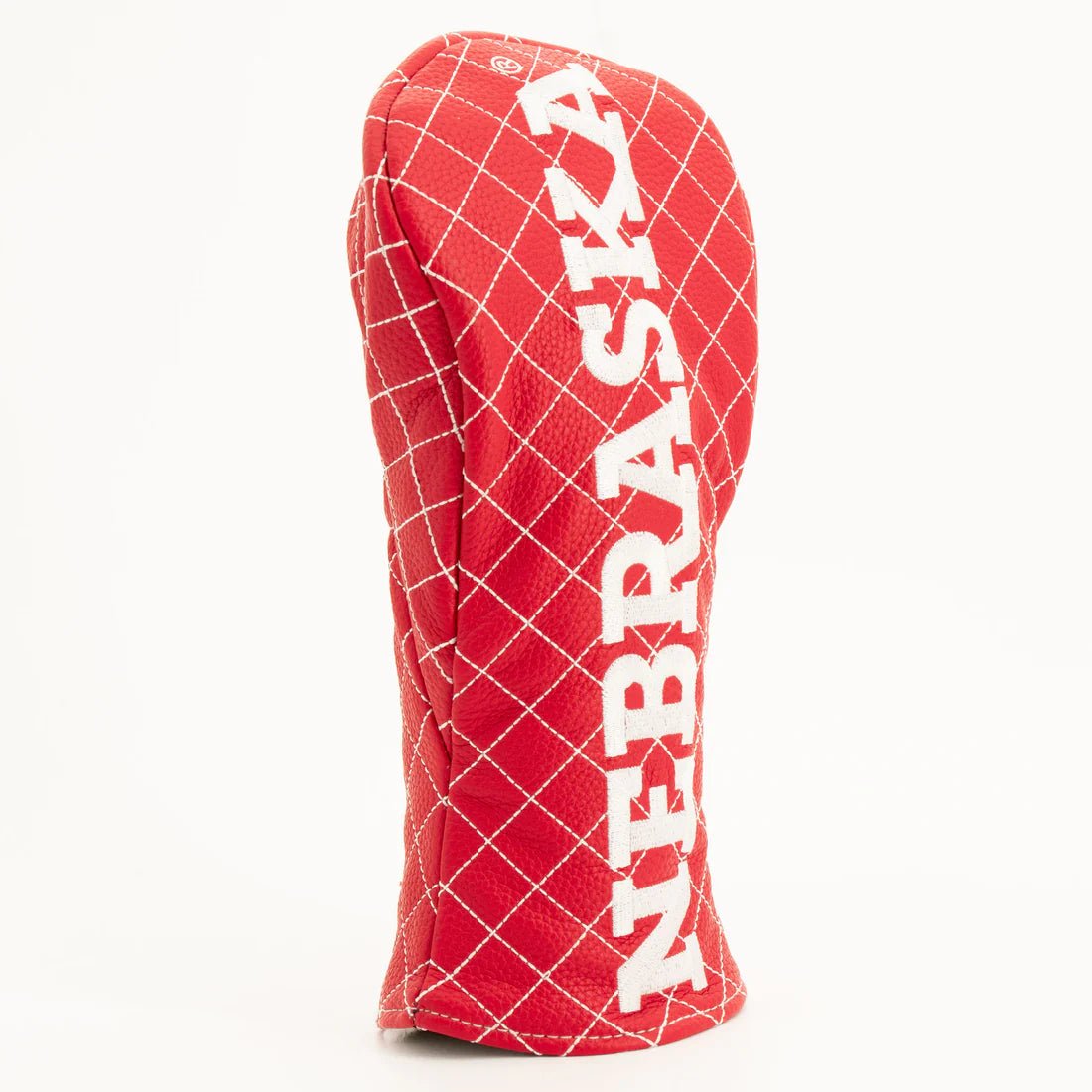 Red grid-patterned golf club head cover with 'NEBRASKA' text on a white background